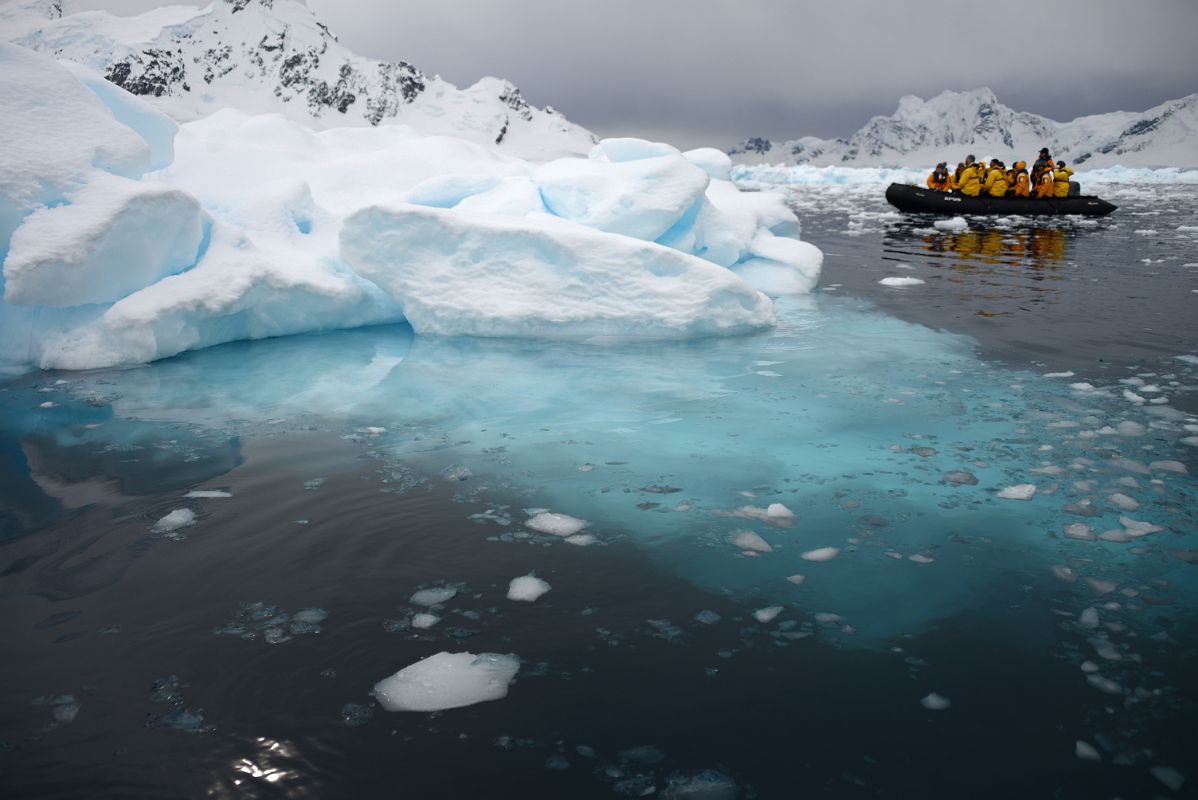 11A Zodiac Next To Iceberg With Blue Portion Below Water In Paradise Harbour On Quark Expeditions Antarctica Cruise